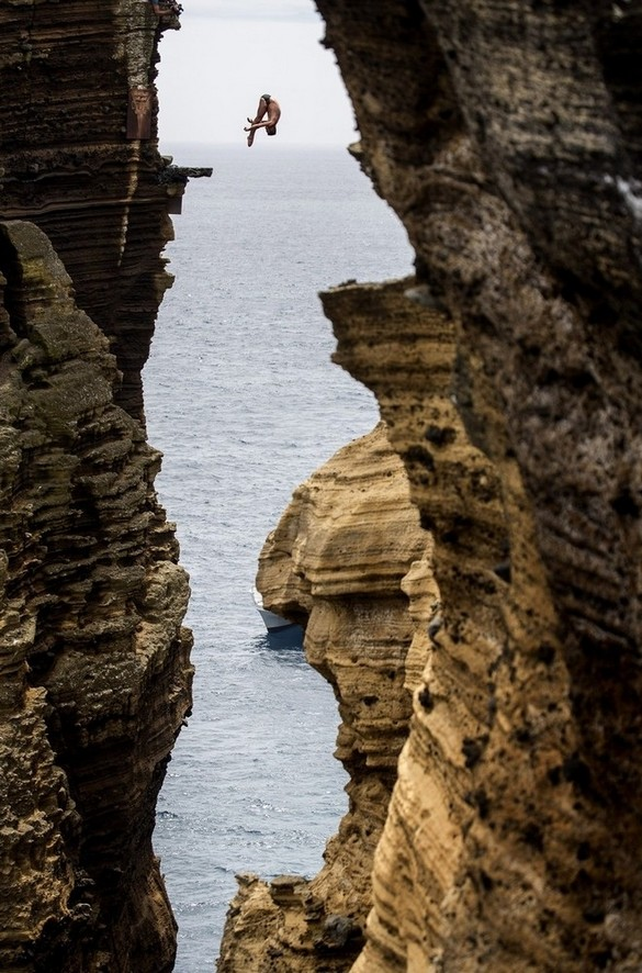 Diving 30 meters through a rock monolith in Portugal.